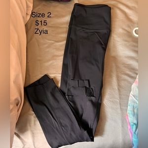 Black Zyia athletic leggings with slits.